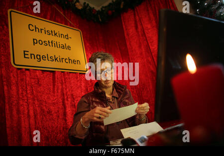 A staff member of the Deutsche Post (German mail service) reads a Christmas wish list from Asia is seen at the Christmas post office in Engelskirchen, Germany, 13 November 2015. Six weeks before Christmas, already more than 6,000 wish lists from children all over the world have arrived at the Christkind Post Office in Engelskirchen. Photo: Oliver Berg/dpa Stock Photo