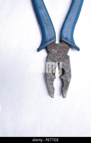 Old pliers on grey metal background with place on text Stock Photo