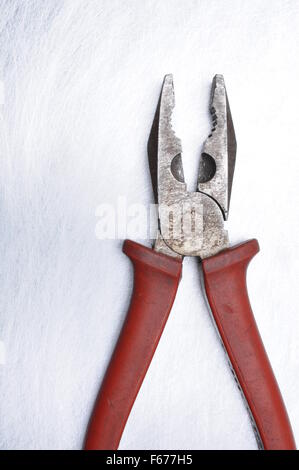 Old pliers on grey metal background with place on text Stock Photo