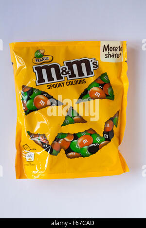 opened packet of crispy M&Ms with contents spilt to spell letters M  isolated on white background Stock Photo - Alamy