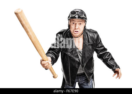 Angry and violent senior biker swinging with a baseball bat isolated on white background Stock Photo