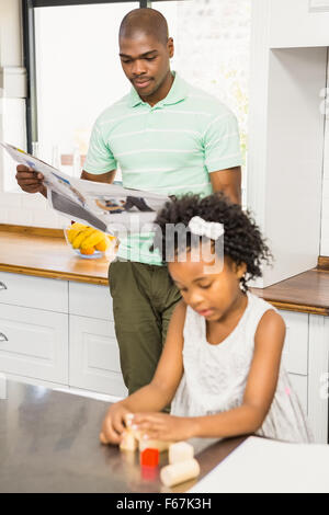 Concentrated father reading newspaper Stock Photo