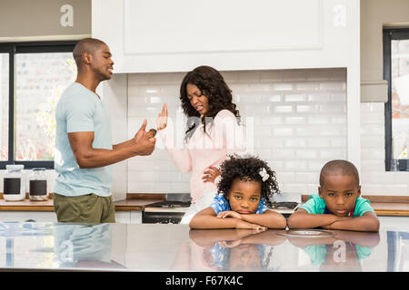 Parents arguing in front of children Stock Photo