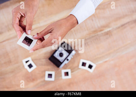 View of hands holding photo slides Stock Photo