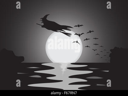 A silhouette of a Halloween witch and bats at moonrise over the sea Stock Photo