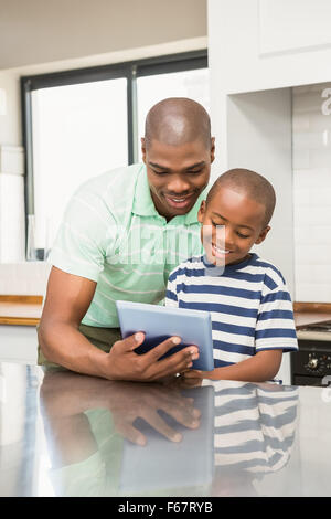 Father using tablet with his son Stock Photo