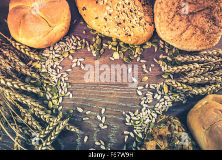 Retro style photo of assortment of loafs of bread and bread rolls Stock Photo