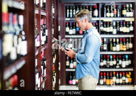 Smiling man holding bottle of wine Stock Photo