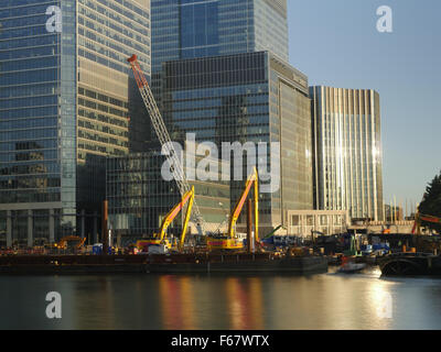 Construction Work in London's Canary Wharf Financial District with Modern Office Buildings and Various Equipment Stock Photo