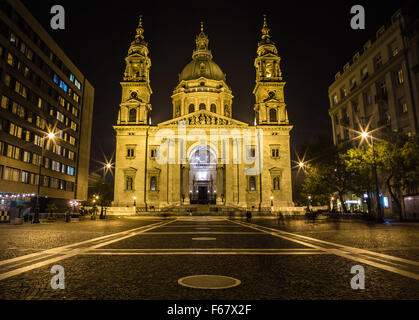 The outside of the front of St. Stephen's Basilica in Budapest at night from the street Stock Photo