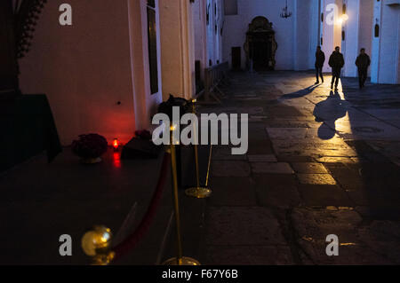 Three people cast long shadows inside the Gothic St. Mary's Church (Basilica of the Assumption of the Blessed Virgin Mary) the l Stock Photo