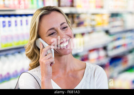 Smiling blonde woman having a call phone Stock Photo