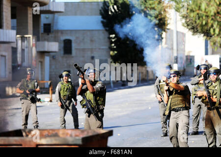 Israeli soldiers fire tear gas canisters into demonstrators (not seen) during clashes with Palestinian youth in the West Bank city of Bethlehem. Following another violent week in the Palestinian Occupied Territories, clashes broke out in the West Bank city of Bethlehem between Palestinian youth and Israeli soldiers. Clashes continued into the evening hours. The recent violence that erupted during the week was condemned by Amnesty International as well as Doctors Without Borders (MSF) after undercover Israeli forces stormed a governmental hospital in the West Bank city of Hebron, shooting and k Stock Photo