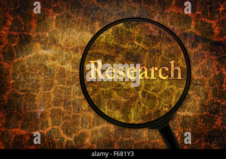 Word Research under a magnifier written on abstract background Stock Photo