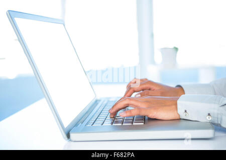 Cropped image of woman using laptop Stock Photo