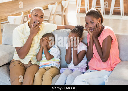 Portrait of a family of four watching tv Stock Photo