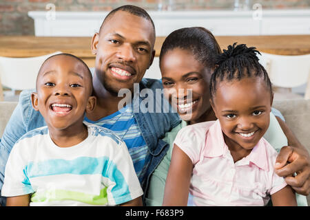 Happy family relaxing on the couch Stock Photo