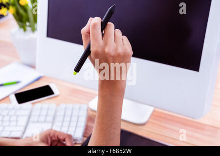 Part of hand holding stylus Stock Photo