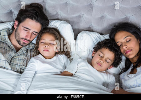 Happy family sleeping together Stock Photo