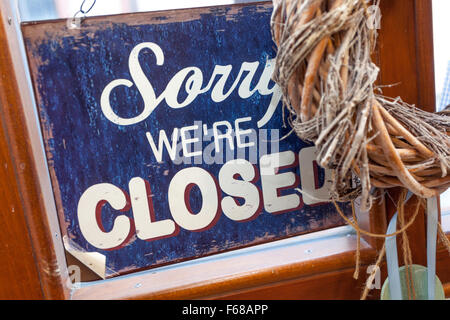 Sorry we're closed sign in shop window, Apology Stock Photo