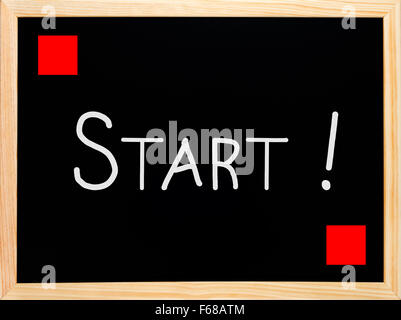 Start and red flag written on blackboard or chalkboard Stock Photo