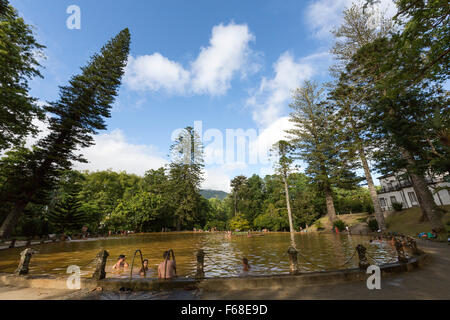 People bathing in the thermal pool of Terra Nostra Garden. Parque Terra Nostra. Furnas. Sao Miguel Stock Photo