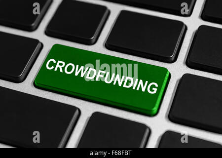 crowdfunding green button on keyboard, business concept Stock Photo