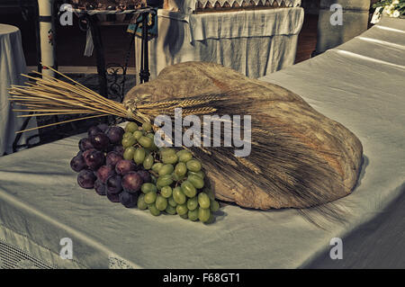 bread, grapes and wheat as a symbol of Christian Communion in a Catholic Church Stock Photo