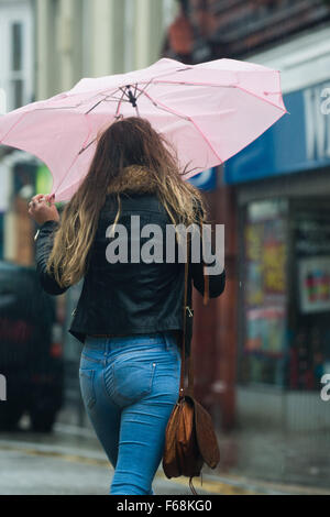Aberystwyth Wales UK, Saturday 14 November 2015    People struggle avoid getting soaked on the streets of Aberystwyth as a band of torrential rain sweeps in from the west in the wake of Storm Abigail.  Amber and red warnings are in place for the risk of severe flooding in north wales and the north or England, with up to  8” (20cm) of rain forecast to fall on already saturated ground in some areas in the next 24 hours       photo Credit:  Keith Morris /Alamy Live News Stock Photo