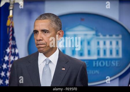 U.S. President Barack Obama pauses while issuing a statement condemning the terror attacks in Paris from the briefing room at the White House November 13, 2015 in Washington, DC. Obama called the attack on Paris an attack on all of humanity. Stock Photo