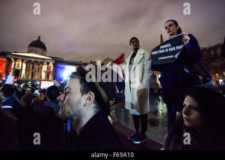 London, UK. 14 Novemeber 2015 Thousands of people gather to pay their respects to the victims of attacks which happened in Paris on the evening of 13th November 2015.  A young woman holds a sign saying 'France your pain is our pain at a rally in Trafalgar Square. Abdullah Bailey/ Alamy Live News Stock Photo