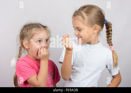 Six year old girl showing her the other girl had fallen Milk front upper teeth Stock Photo