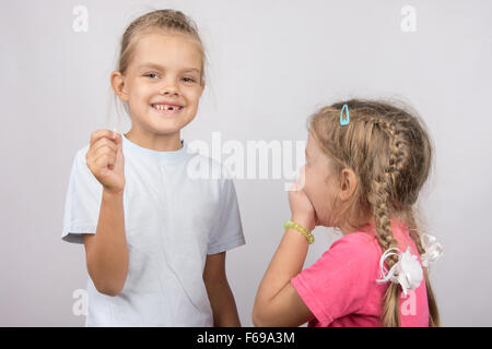 Six year old girl showing her the other girl had fallen Milk front upper teeth Stock Photo