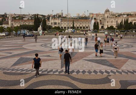 LISBON, PORTUGAL - OCTOBER 24 2014: People walking on the floor wind rose of Belem, with Jeronimos Monastery in the background Stock Photo