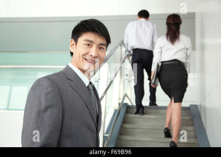 Businesspeople Going Up Stairs Stock Photo