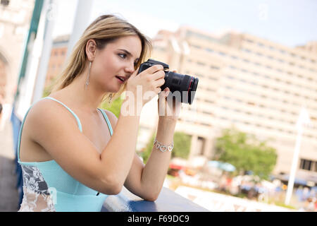 young woman taking a photo Stock Photo