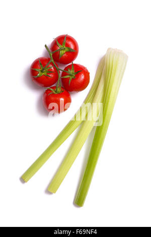 Bunch of fresh tomatoes and celery sticks, top view isolated on white background Stock Photo