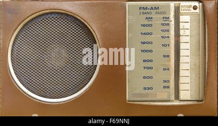 An old portable transistor radio in a brown plastic cover Stock Photo