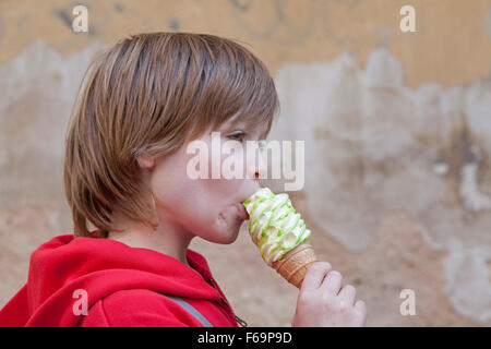 young boy eating an ice cream cone Stock Photo