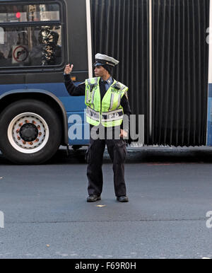 A female New York City Traffic Enforcement Officer directing cars at East 34th Street and Park Avenue in New York City. Stock Photo