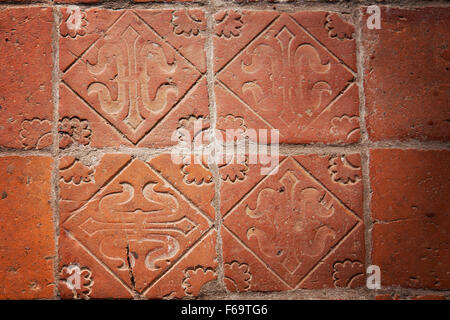 Image of medieval hand-made teracotta floor tiles. Stock Photo