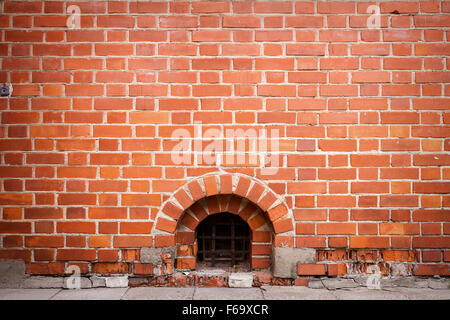 Red brick wall with a window Stock Photo