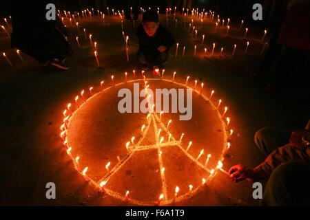 Kathmandu, Nepal. 15th Nov, 2015. Nepalese people form the shape of the Eiffel Tower with candles during a candlelight vigil in memory of the victims killed in the Friday's attacks in Paris, in Kathmandu, Nepal, Nov. 15, 2015. Credit:  Pratap Thapa/Xinhua/Alamy Live News Stock Photo