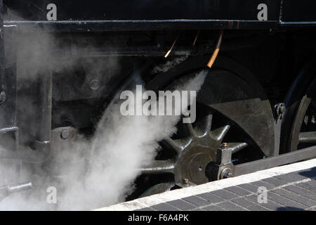 A view of steam escaping from a vintage steam engine belonging to the Kent and East Sussex railway in England. Stock Photo