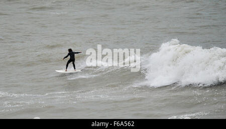Brighton, UK. 15th Nov, 2015. A surfer makes the most of the high winds enjoying catching the waves off Brighton beach this afternoon The remnants of Hurricane Kate are forecast to affect areas of Britain throughout the next few days Credit:  Simon Dack/Alamy Live News Stock Photo