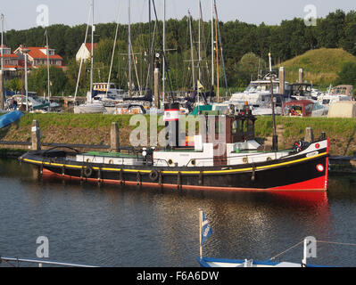 The Dianne, an ENI 02203256 registered vessel, is a container ship and oil tanker operating in the harbor of Tholen, Netherlands. This image captures the ship docked alongside cranes and containers, part of the logistics and transport network for general goods and bulk shipments including gas, coal, and grain. The vessel plays a key role in the transportation industry, moving goods through the busy Dutch waterways. Stock Photo