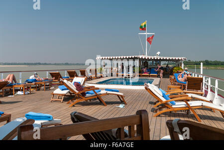 Pool deck of the 'Road to Mandalay', a luxury cruise ship on the Irrawaddy river in Myanmar. Stock Photo