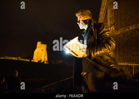 Aberystwyth, Wales, UK. 15 Nov, 2015.   Aberystwyth university student Ross Payton speaking at an emotional candle-lit vigil on the steps of the town’s iconic war memorial,  in memory of all those killed in the Paris terrorist attacks of November 13 2015    photo Credit:  Keith Morris / Alamy Live News Stock Photo