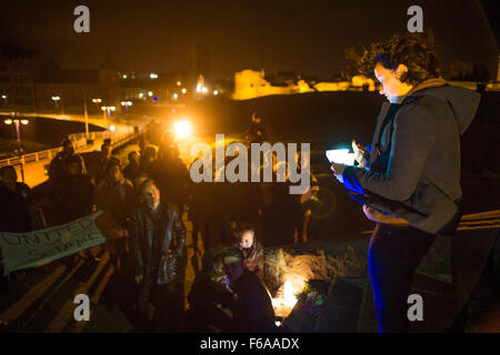 Aberystwyth, Wales, UK. 15 Nov, 2015.   Aberystwyth university student Amelia Robert speaking at an emotional candle-lit vigil on the steps of the town’s iconic war memorial,  in memory of all those killed in the Paris terrorist attacks of November 13 2015    photo Credit:  Keith Morris / Alamy Live News Stock Photo