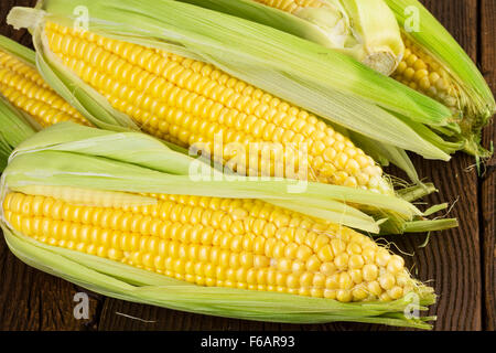 Corn cob over wood Stock Photo